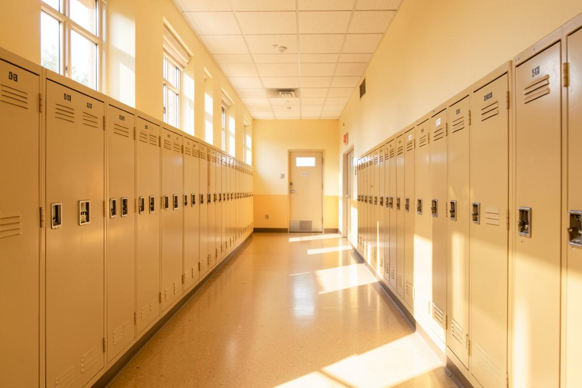 Sunlit school hallway lined with lockers